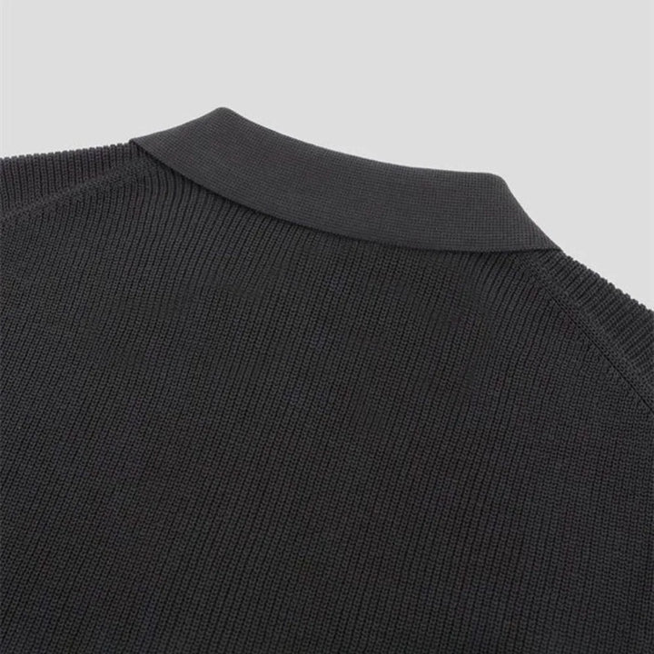 Man wearing a dark men's tailored fit zip-up polo shirt, highlighting its comfortable and stylish appeal.