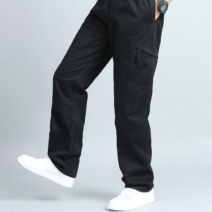 Close-up of the multi-pocket detail on men's durable cargo pants, built for maximum utility.