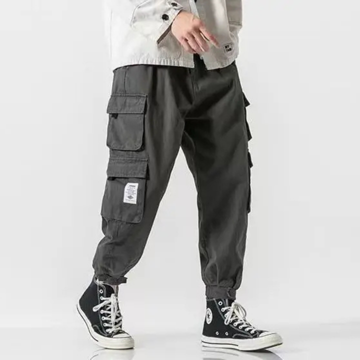Man wearing comfortable men's cargo joggers, tapered fit, perfect for casual utility & everyday wear.