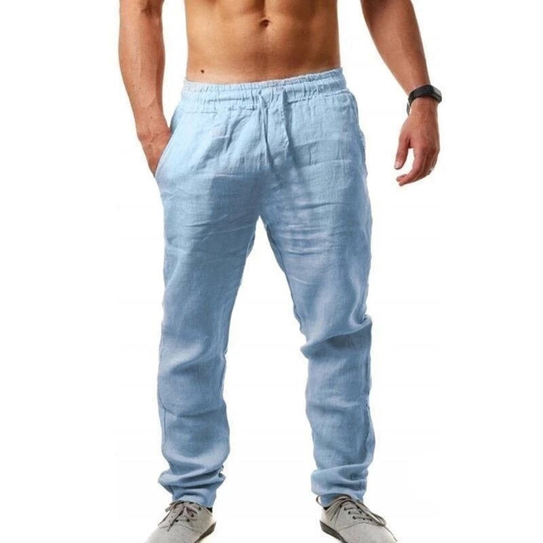 Man wearing comfortable, airy Noah linen trousers, ideal for a relaxed summer day. Breathable men's pants.