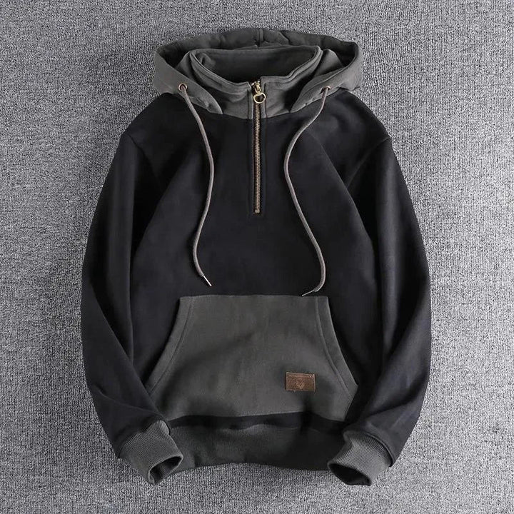 Modern men's quarter-zip hoodie, two-tone design for urban explorer fashion. Comfortable, durable casual wear.