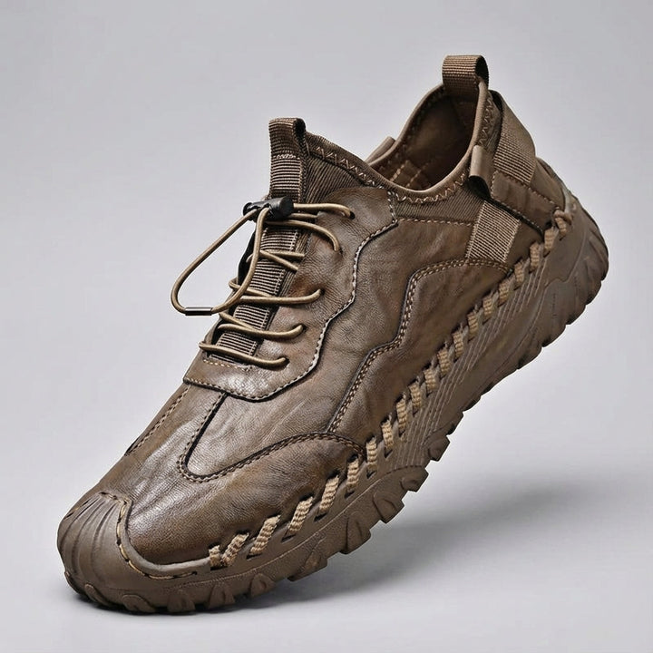 Pair of black and grey men's non-slip outdoor sneakers against a natural background