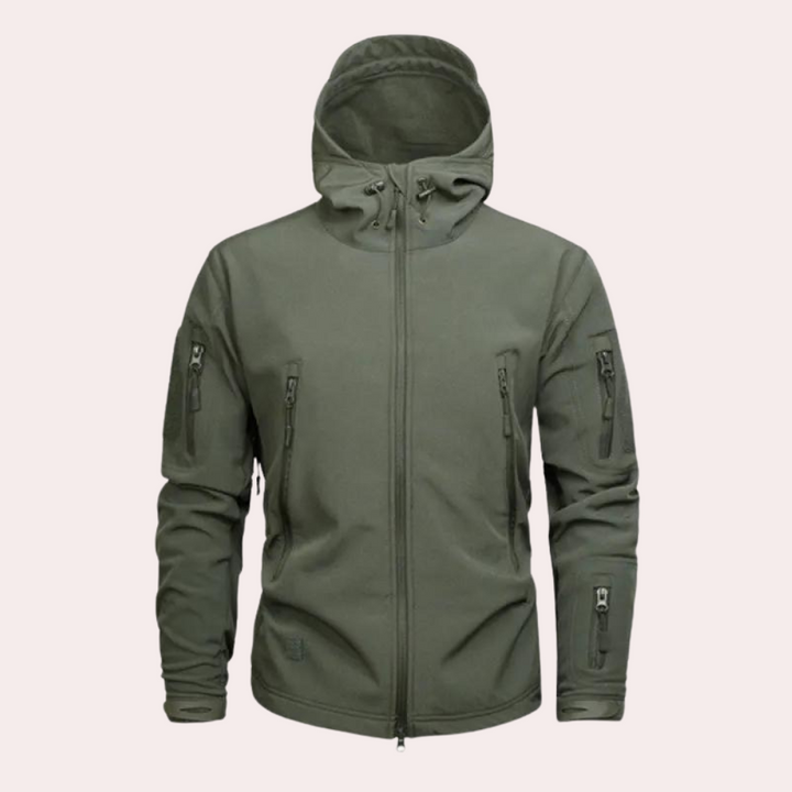 Man in Orson men's weather-resistant jacket, hiking a trail. Versatile adventure gear for rugged outdoors.