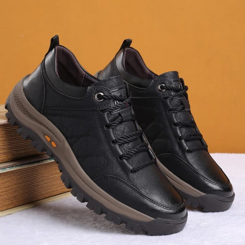 Close-up of premium brown leather texture on men's orthopedic casual shoes for comfort & durability.