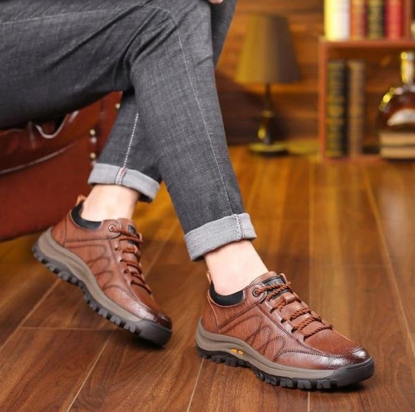 Men's feet in comfortable orthopedic brown leather walking shoes for daily support, pain relief & casual wear.