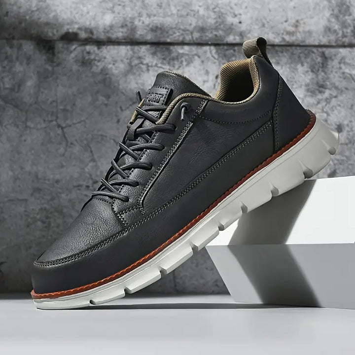 Close-up of breathable mesh fabric on men's comfort sneakers. Supportive orthopedic design for daily wear.