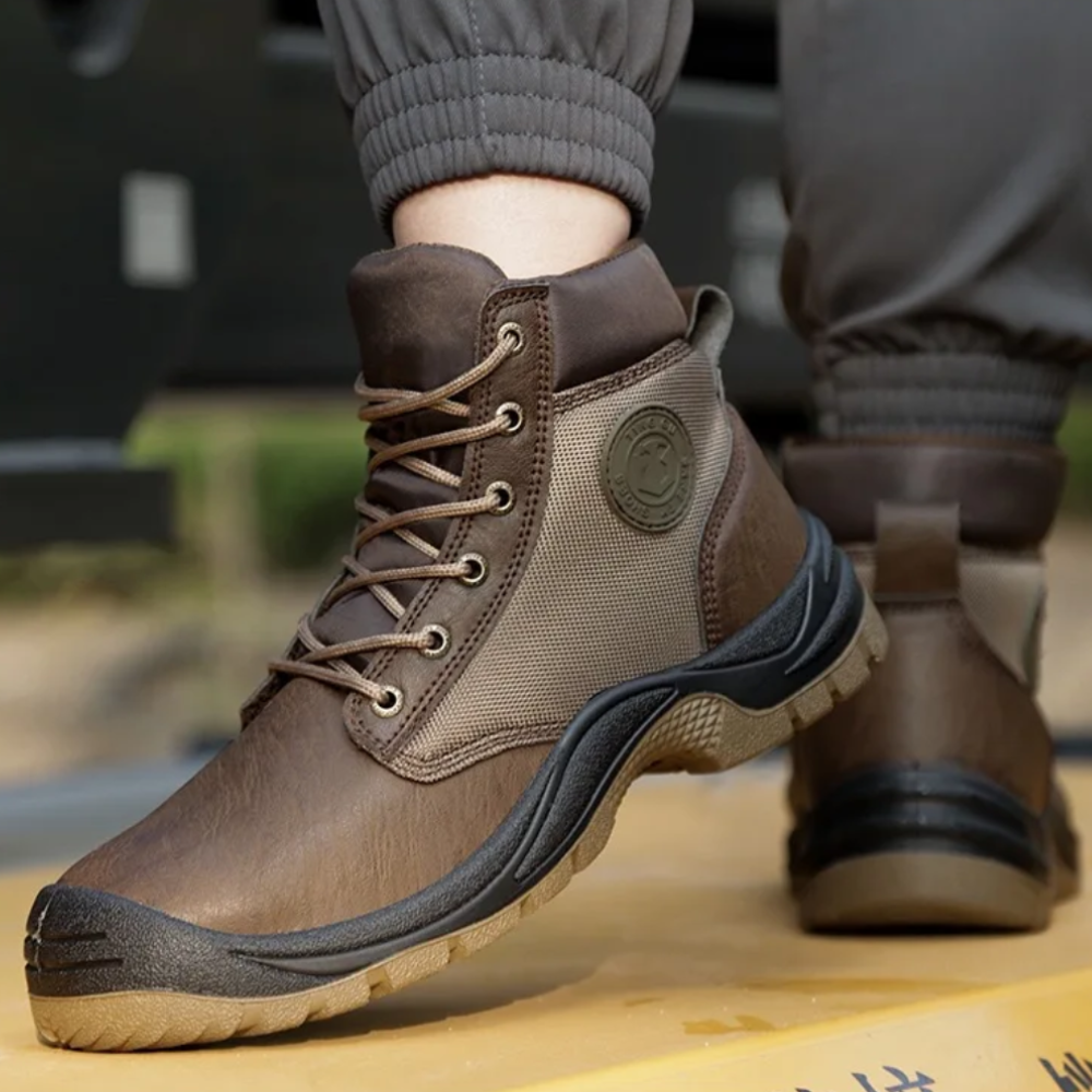 Black men's protective footwear with steel toe and ergonomic design for industrial work safety & foot support.