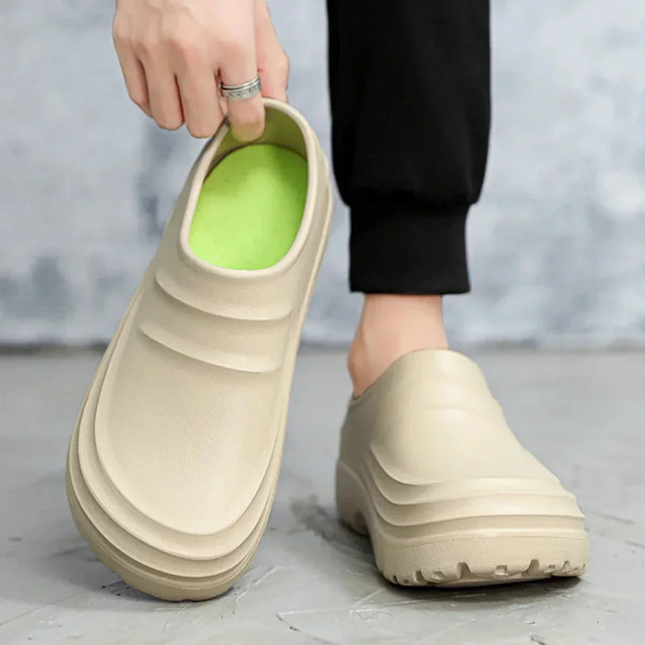 Orthopedic men's work clogs, waterproof & slip-resistant, ensuring all-day foot comfort.