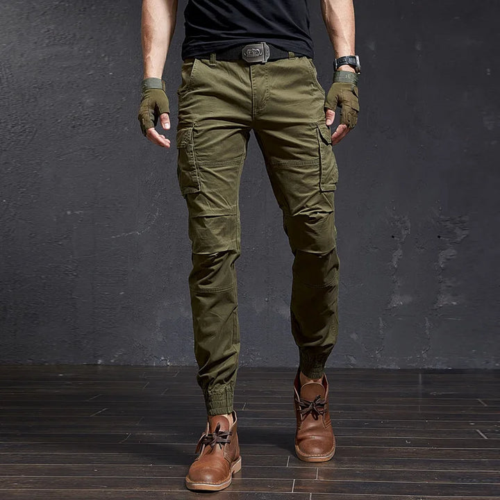 Men's Outland tapered tactical cargo pants in rugged style, featuring utility pockets & cuffed ankles for streetwear.