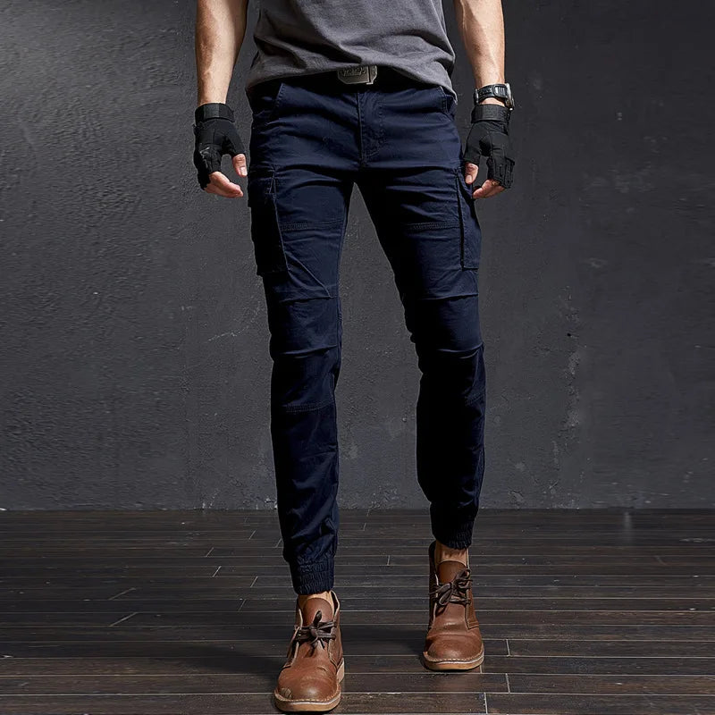 Front view of men's Outland tapered fit cargo pants with large utility pockets & elastic cuffed ankles for adventure.