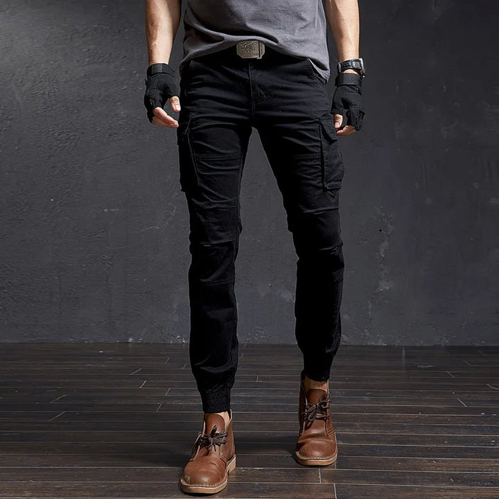 Outland men's tapered tactical cargo pants with practical utility pockets, a cuffed ankle, and rugged streetwear style.