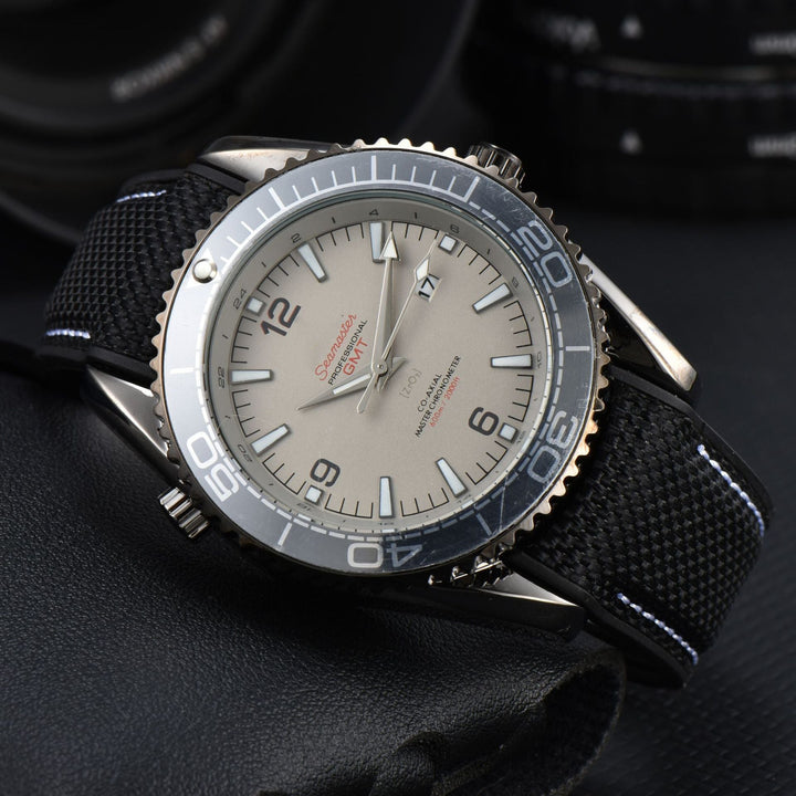 Close-up of a men's sport watch featuring a black woven strap, rotating bezel, & luminous markers.