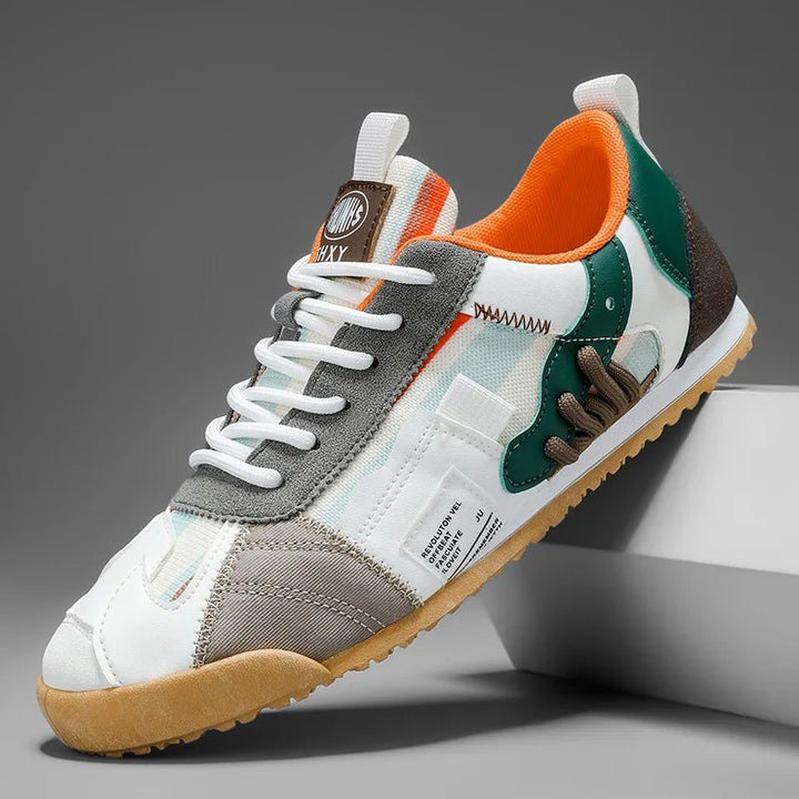 Side view of men's utility sneakers, featuring unique patchwork design & durable trail sole.