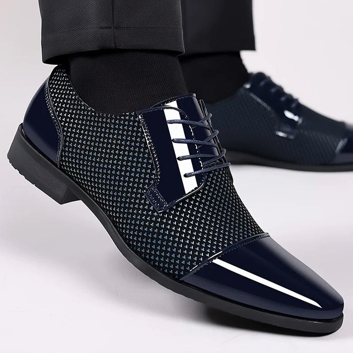 Close-up of men's patterned knit oxford shoes, showcasing intricate texture and design.