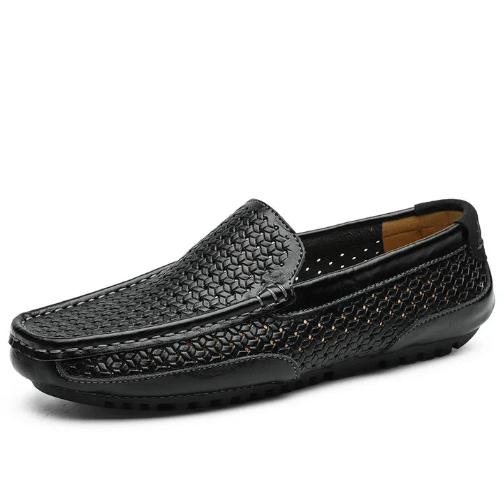 Close-up of men's perforated slip-on loafers, highlighting texture and breathable design.