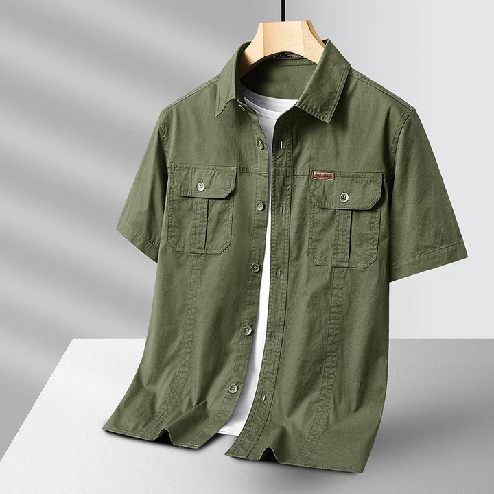Men's performance button-up shirt in blue, quick-dry & moisture-wicking for all-day comfort & travel.