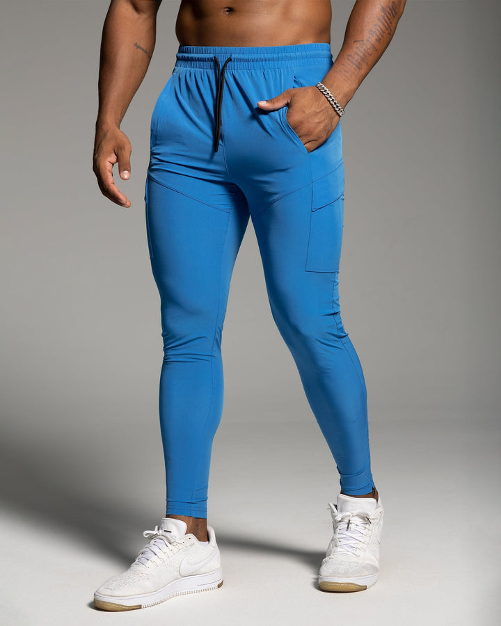 Model wearing men's activewear joggers during a dynamic workout, highlighting flexibility & fit.