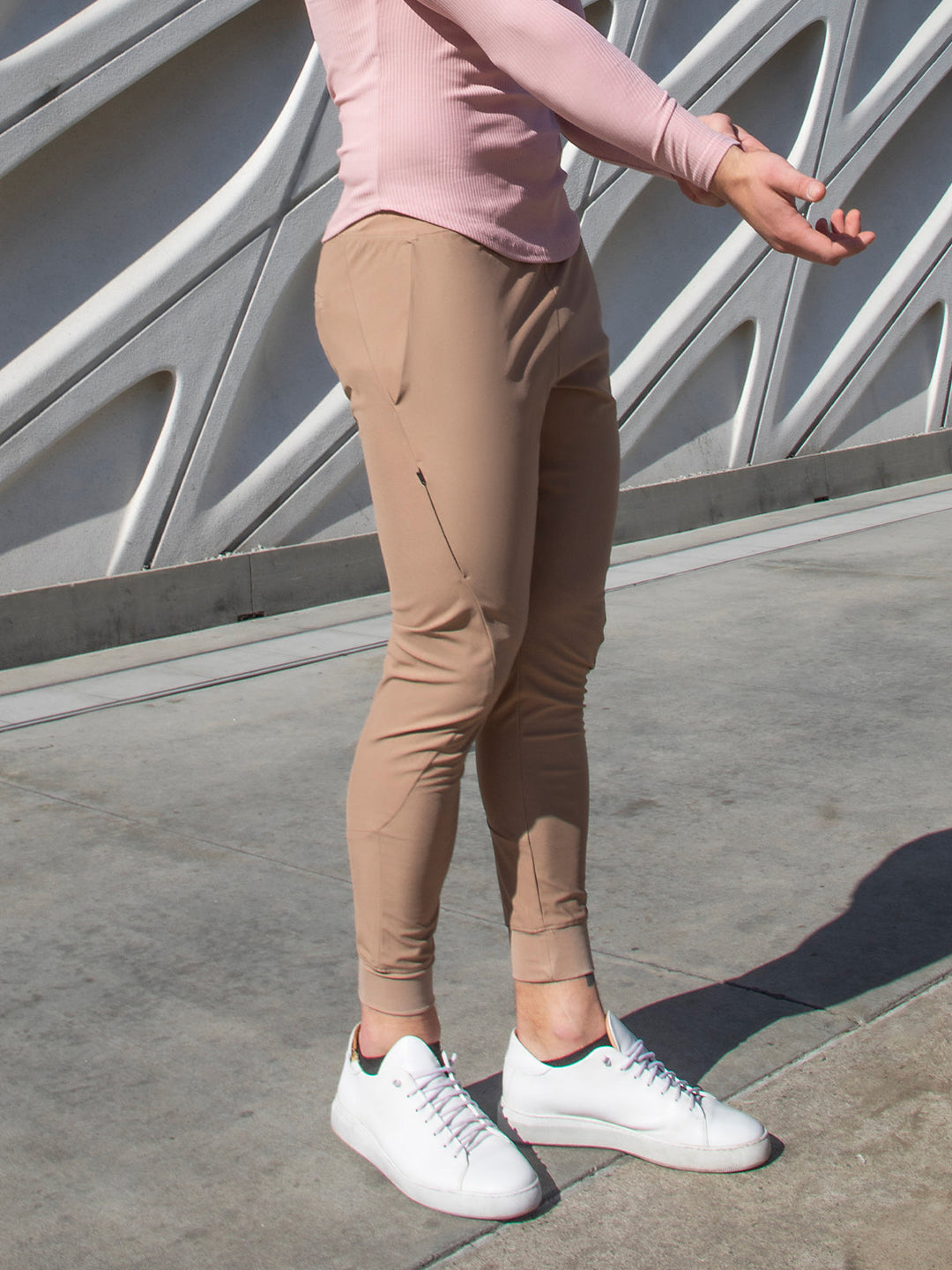 Man lifting weights in men's gym pants, performance joggers designed for active days.