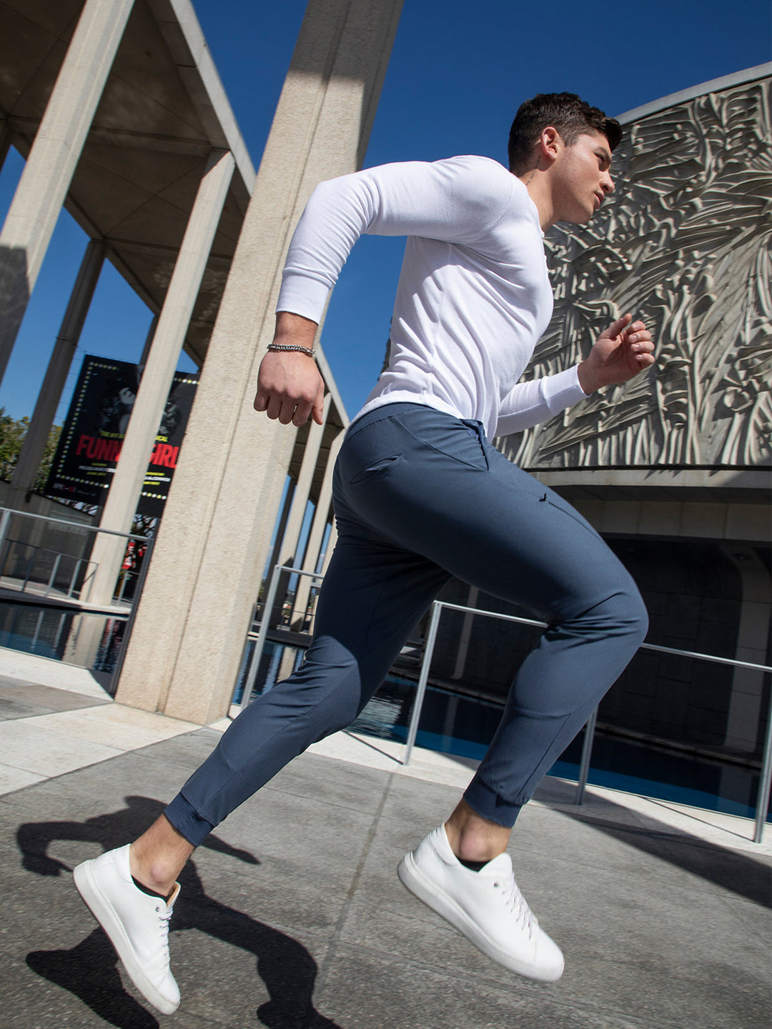 Man wearing sleek men's performance joggers, showcasing athletic style & modern fit activewear.