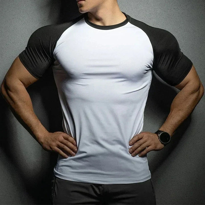 Performance men's muscle-fit shirt. Form-fitting athletic wear, perfect for gym or casual fashion, enhancing physique.