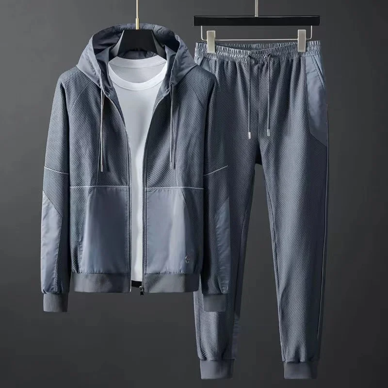 Men's performance techwear tracksuit set, sleek black hoodie & joggers for athletic activities.