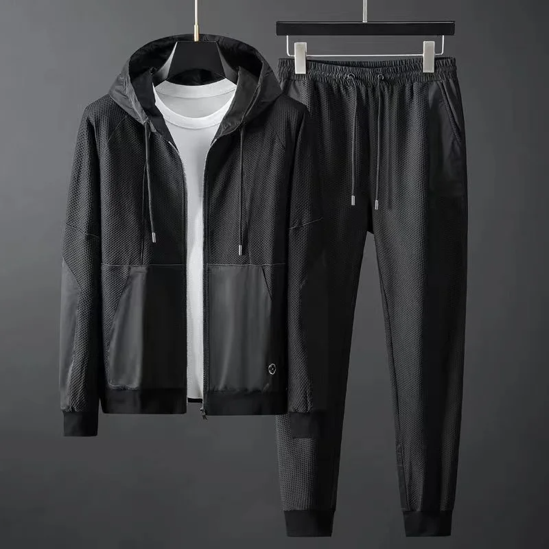 Men's athletic techwear tracksuit set featuring performance joggers and matching hoodie.