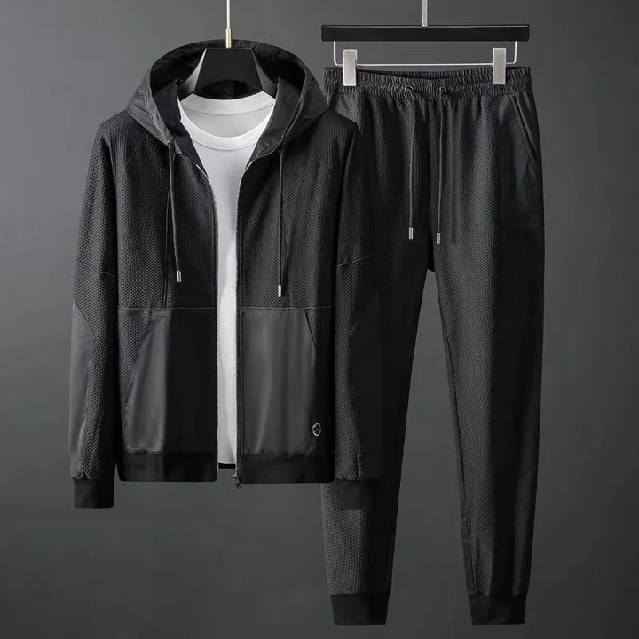 Men's athletic techwear tracksuit set featuring performance joggers and matching hoodie.