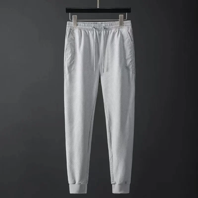 Modern men's urban fashion techwear tracksuit, an athletic set for casual and active wear.