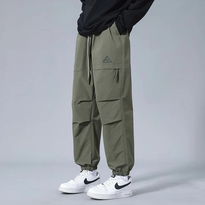 Black men's performance joggers with a stylish tapered fit, ideal activewear for gym or casual outings.