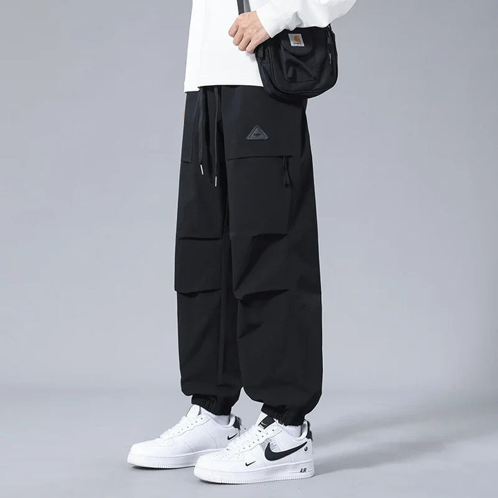Comfortable men's joggers with a drawstring waist and secure zippered utility pockets, great for active lifestyles.