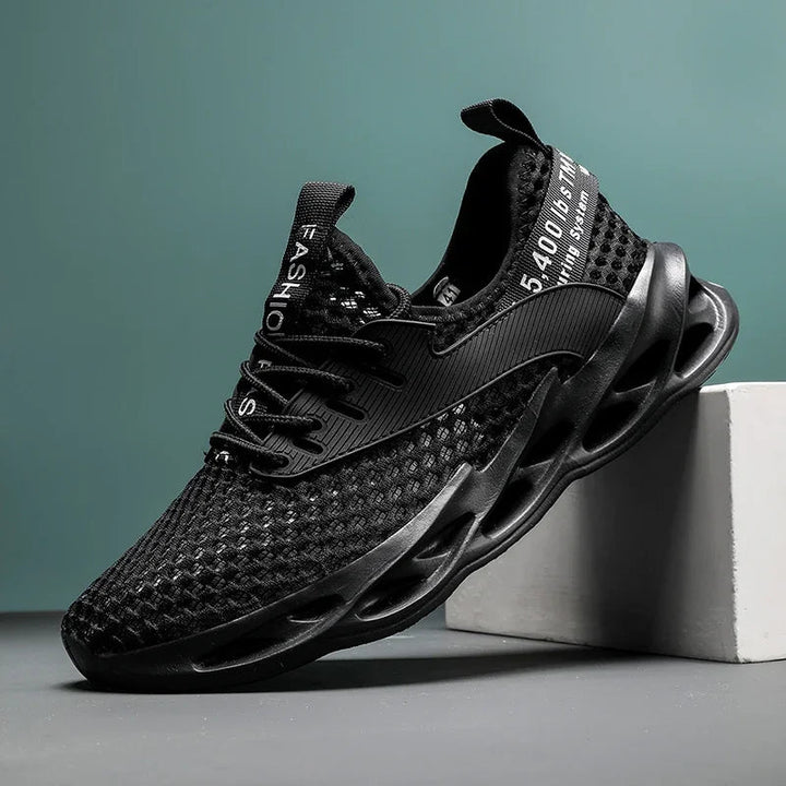 Sole of men's camo running shoes, showcasing traction pattern & cushioned design for sports.