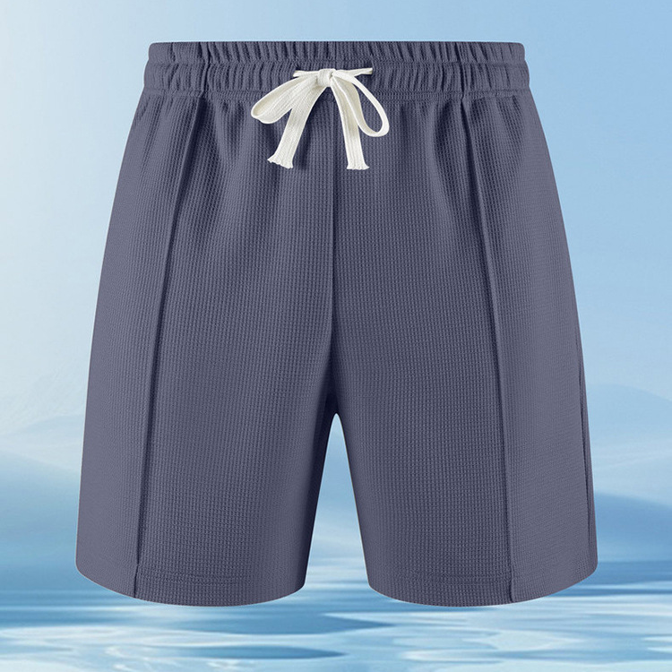 Close-up of the textured piqué knit fabric on a men's casual lounge set with zip collar.