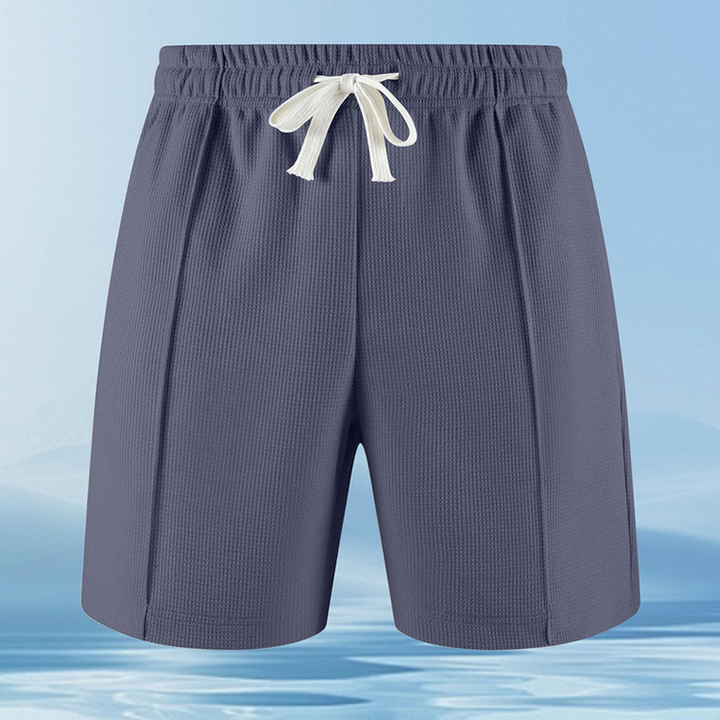 Close-up of the textured piqué knit fabric on a men's casual lounge set with zip collar.