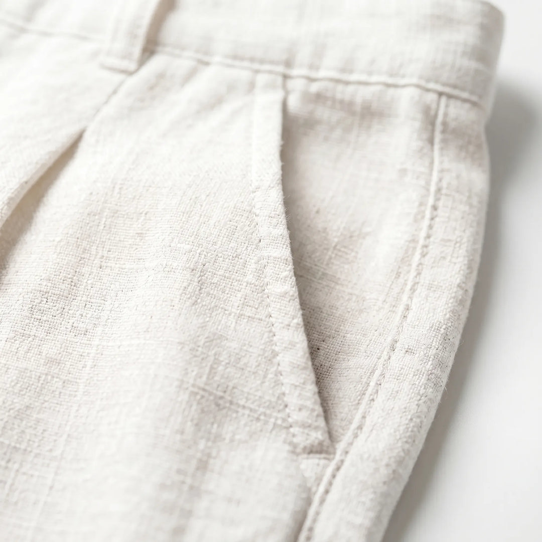 Ankle-length men's pleated trousers, ideal for summer fashion and versatile smart casual outfits.