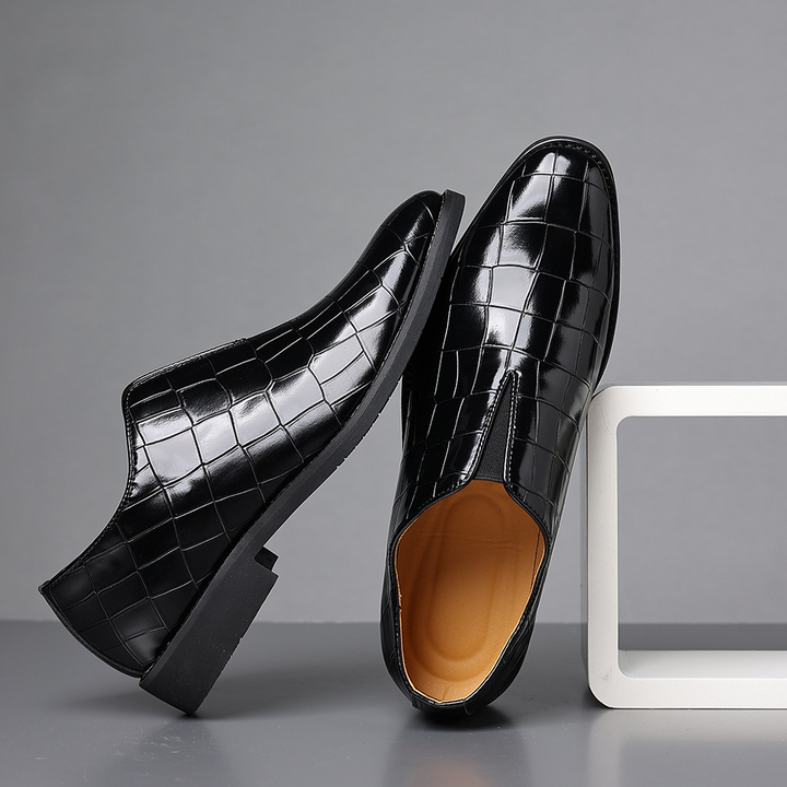 Black men's polished dress shoes, essential for any formal business wardrobe and elegant events.