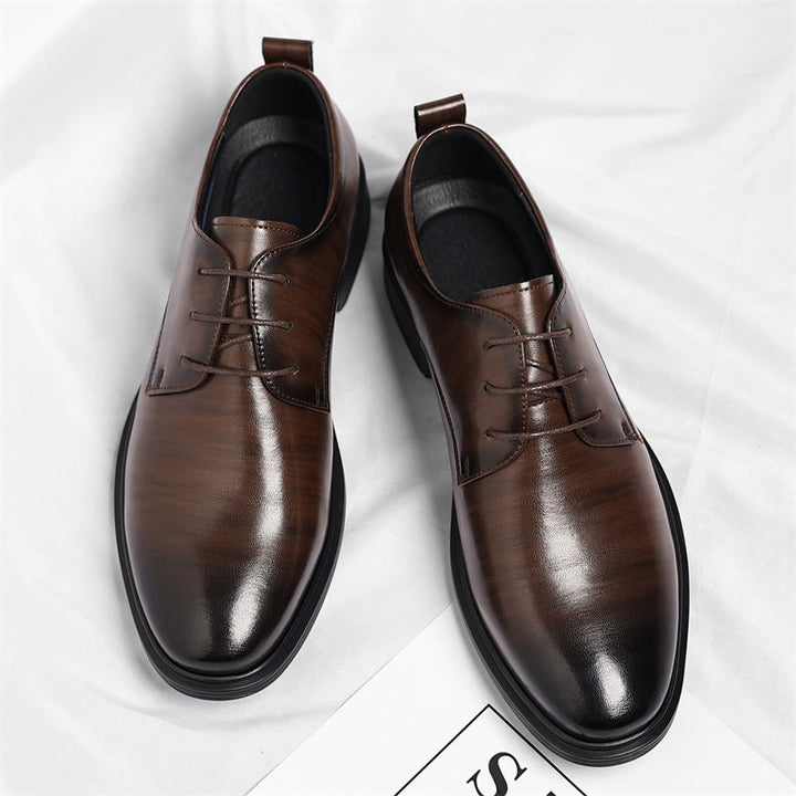 Close-up of polished black men's dress shoe, highlighting comfortable leather texture & formal style.