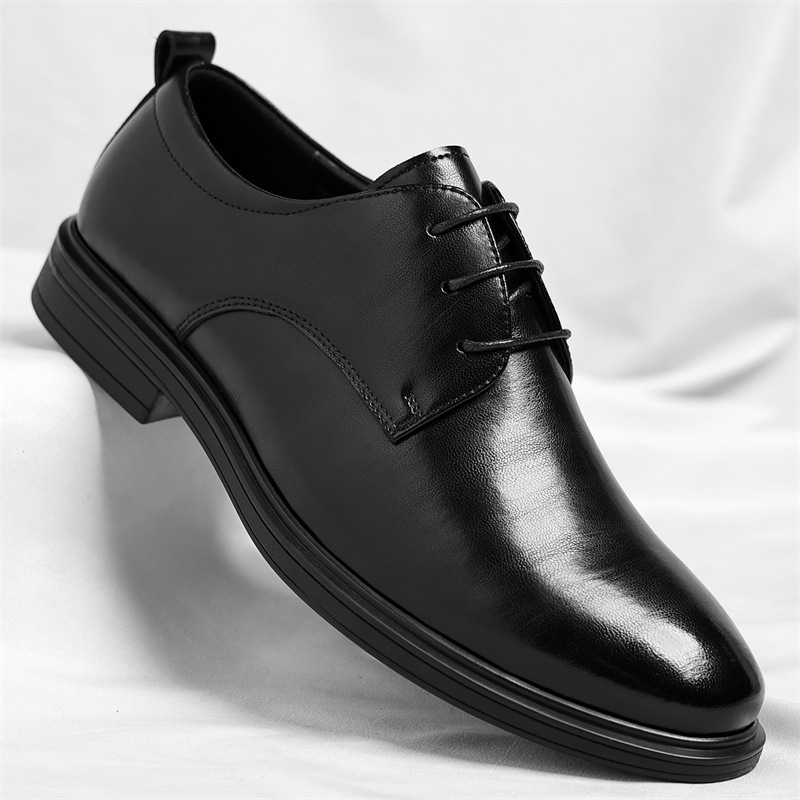 Stylish men's polished black dress shoes complementing a formal business outfit. Comfortable footwear.