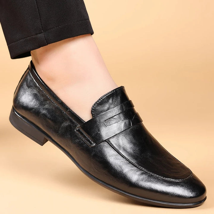 Men's professional black leather slip-on loafers, polished for a sharp, classic look.