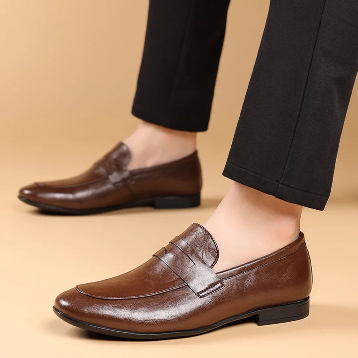Sleek brown polished leather slip-on loafers for men, perfect formal and business attire.
