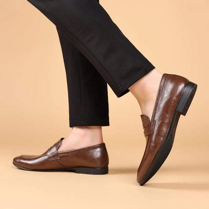 Durable men's black polished leather slip-on dress shoes, essential for professional wardrobe.