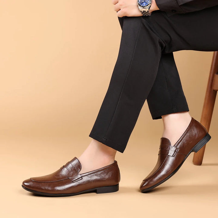 Fashionable men's brown leather loafers, polished slip-on style for modern professionals.