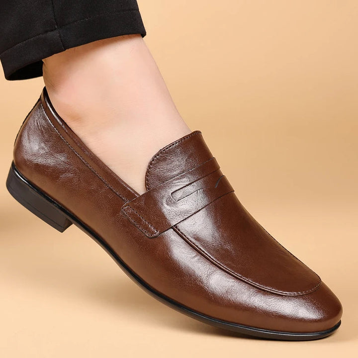 Classic men's polished black leather loafers, slip-on design for ultimate professional ease.