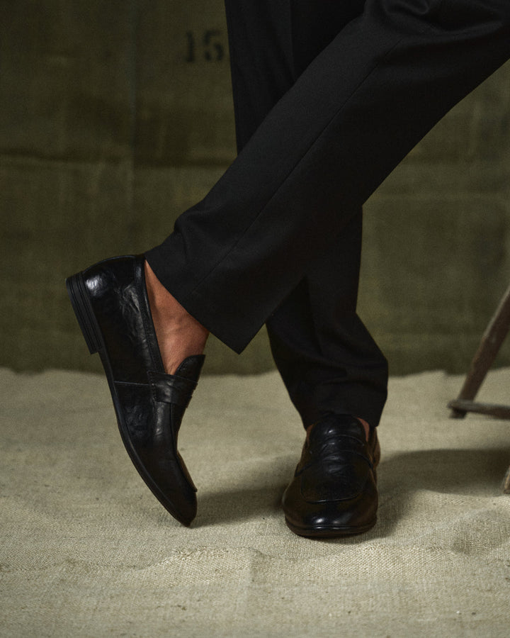 Stylish men's brown polished leather loafers, perfect for business casual and formal wear.