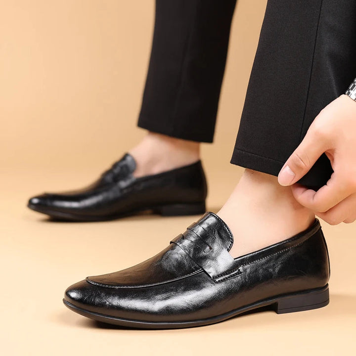 Smart men's formal brown leather slip-on shoes, polished finish for a professional outfit.