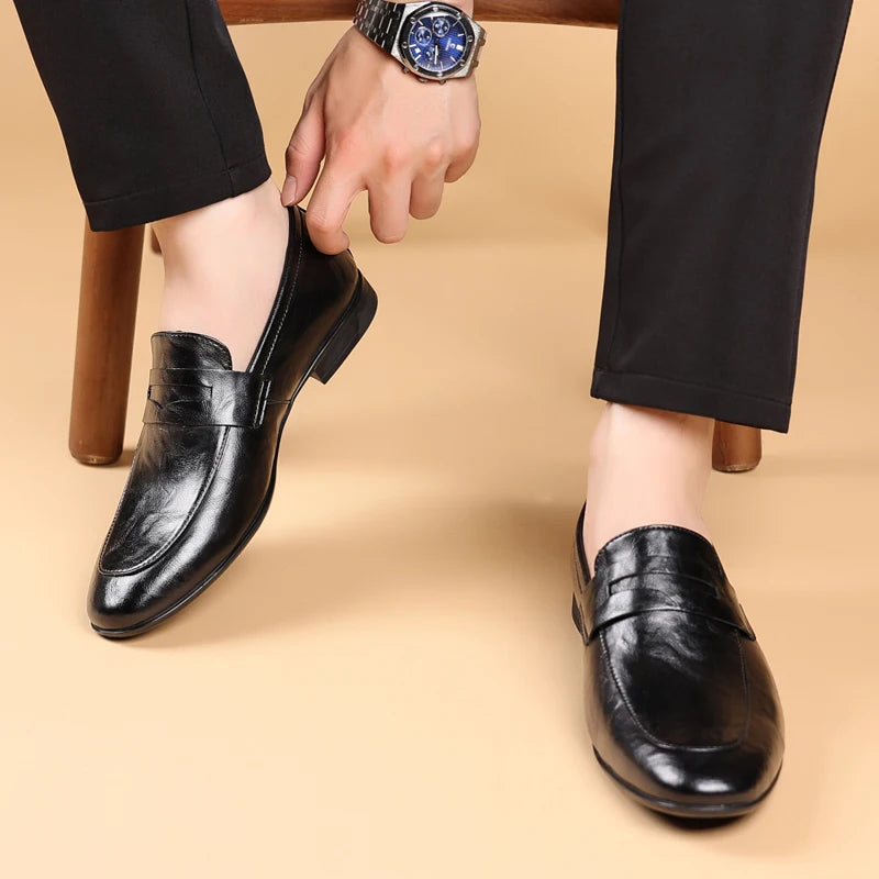 Comfortable black polished leather loafers for men, ideal slip-on professional dress shoes.