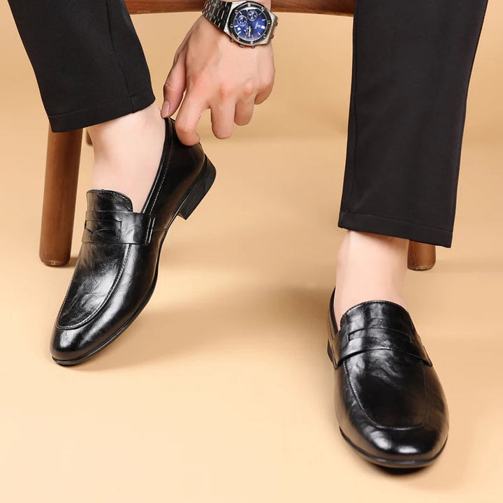 Comfortable black polished leather loafers for men, ideal slip-on professional dress shoes.