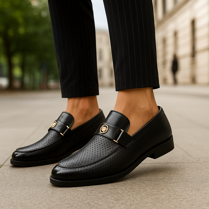 Men's polished black slip-on loafers on a model, styled for business casual and all-day comfort.