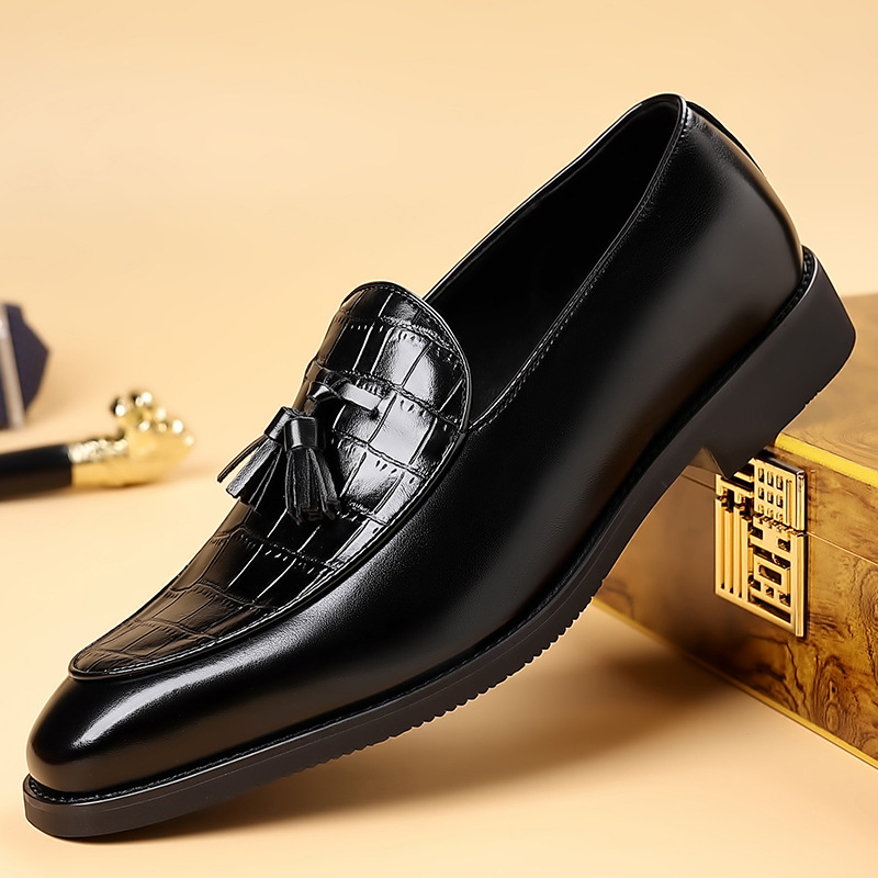Men's polished black tassel loafers. Elegant slip-on dress shoes for formal and business casual style.