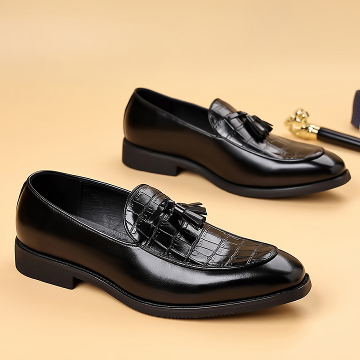 Textured brown leather men's tassel loafers. Comfortable slip-on dress shoes for sophisticated gentlemen.