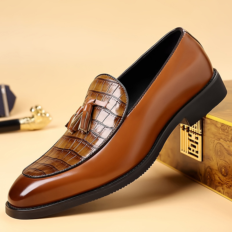 Brown leather men's tassel loafers. Detailed slip-on formal shoes for elegant, comfortable wear.